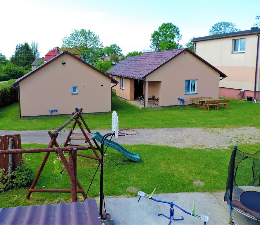a yard with two houses and a playground at Jacek i Agatka in Ustka