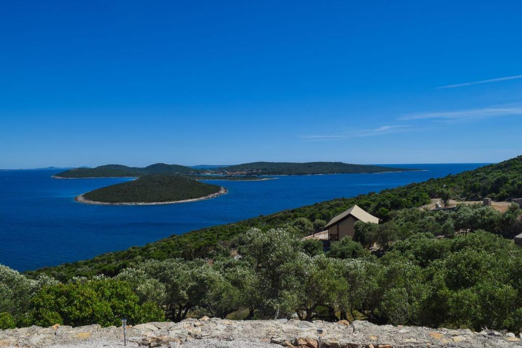 a large body of water surrounded by mountains at Glamping Tents and Mobile Homes Trasorka in Veli Lošinj