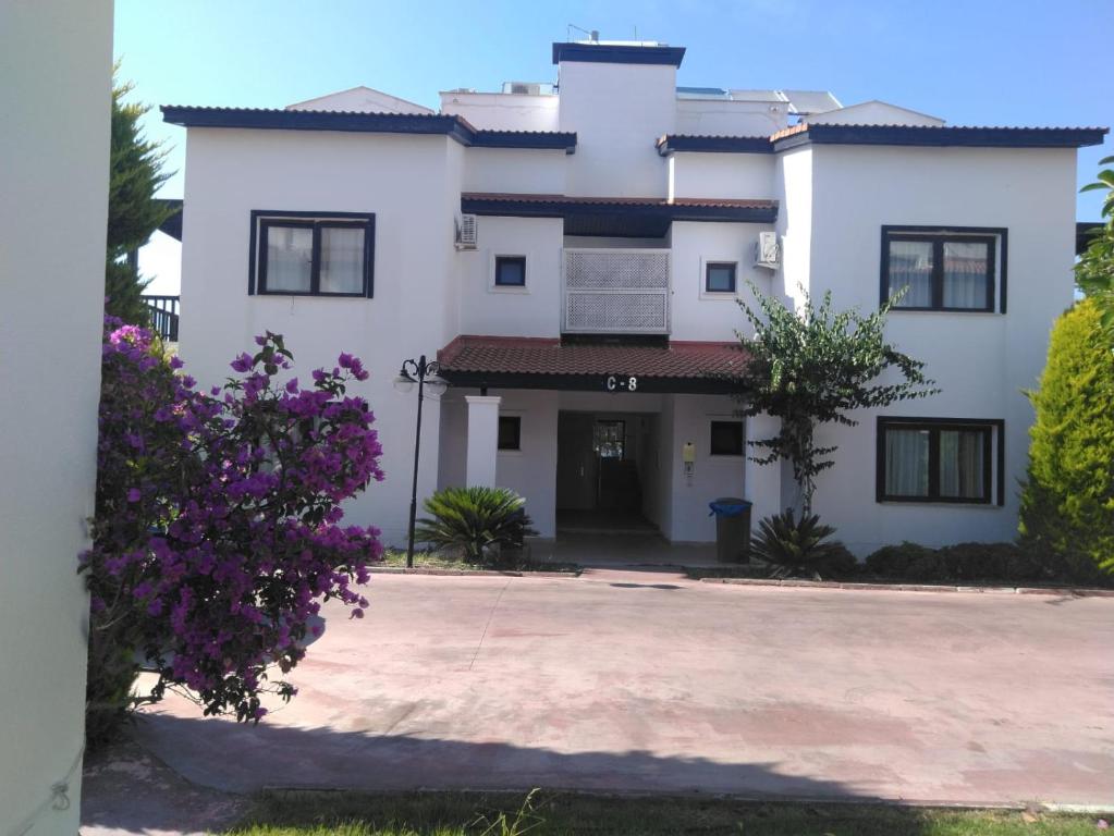 a large white house with a driveway at Cozy and Luxury Apartment in Amazing Facility in Belek