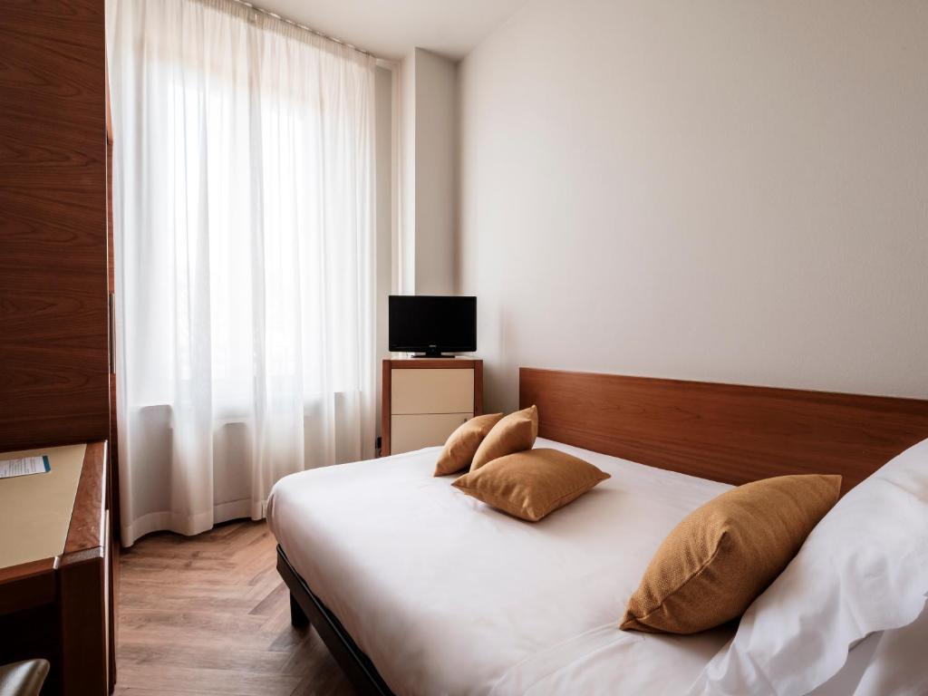 Postel nebo postele na pokoji v ubytování Hotel Lory