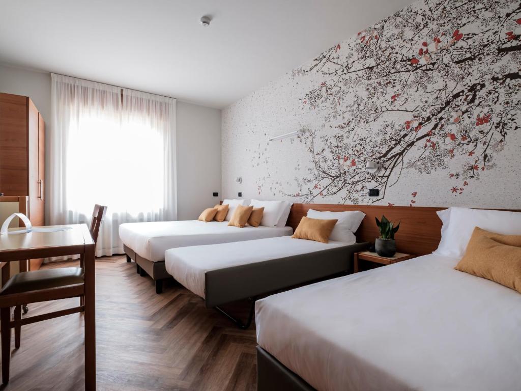 Postel nebo postele na pokoji v ubytování Hotel Lory