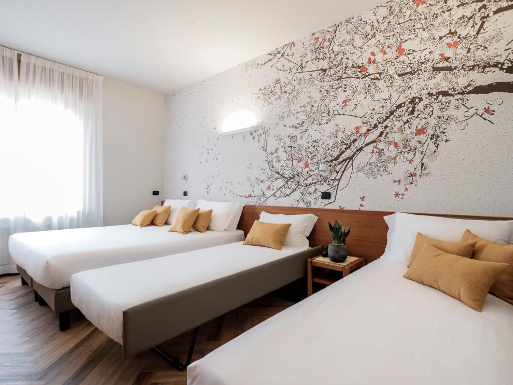 Postel nebo postele na pokoji v ubytování Hotel Lory
