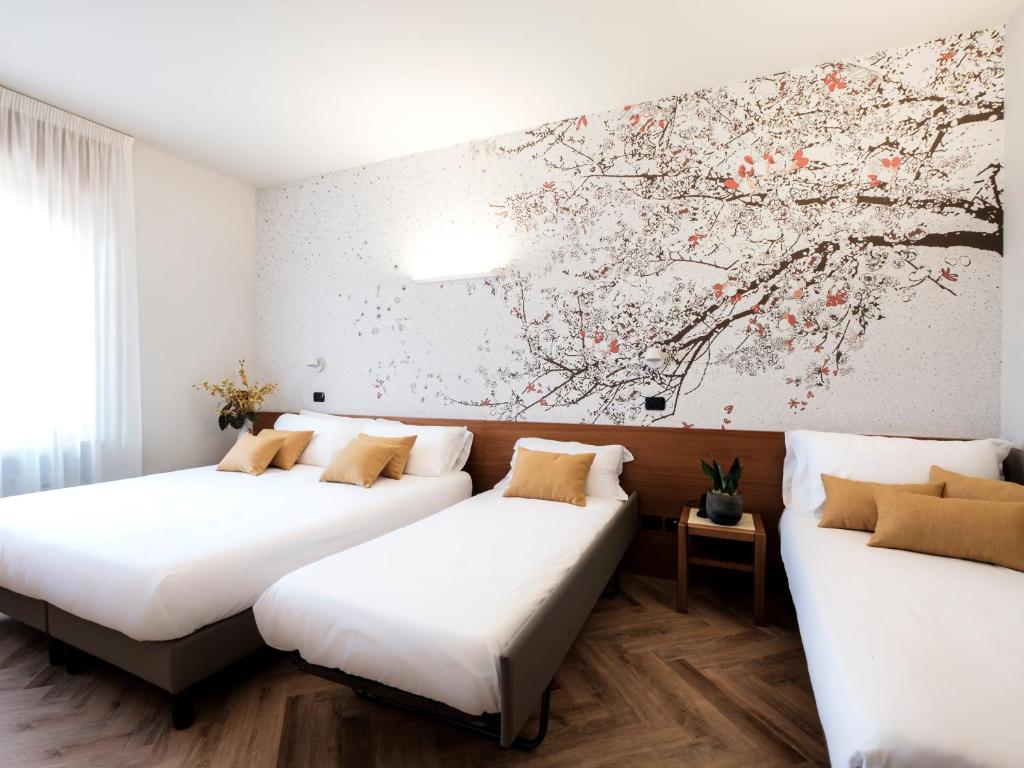 Postel nebo postele na pokoji v ubytování Hotel Lory