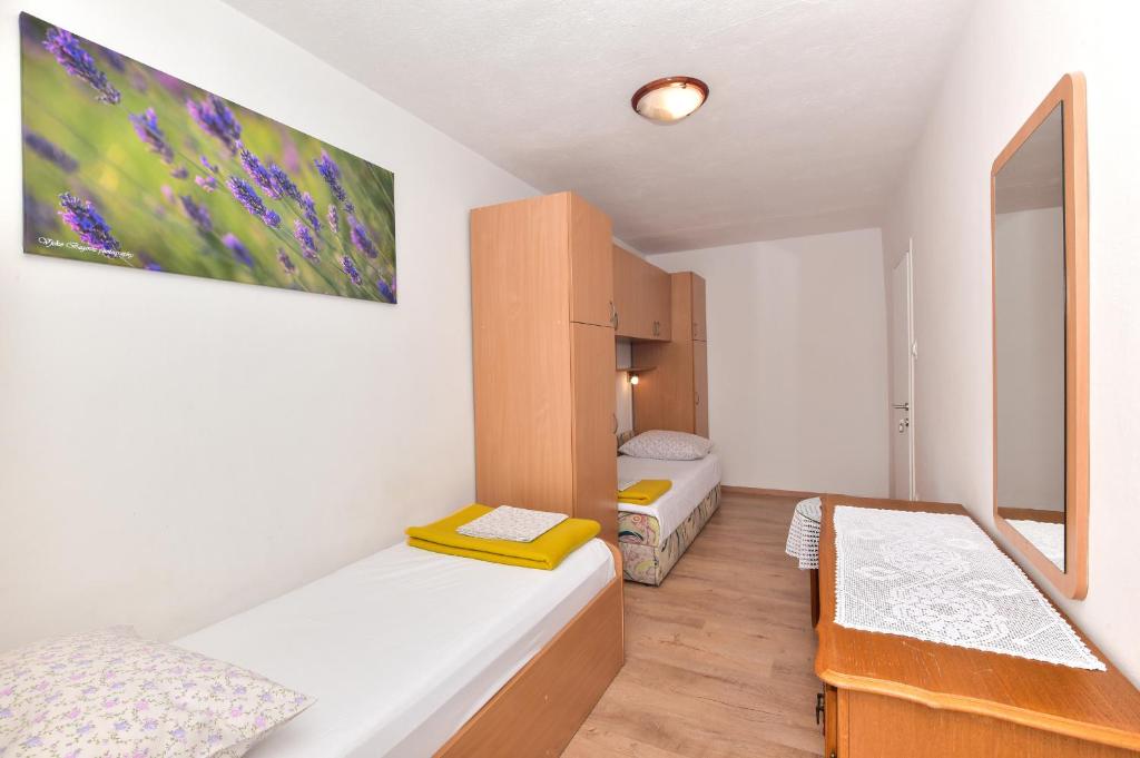 Postel nebo postele na pokoji v ubytování Apartments Vjeko