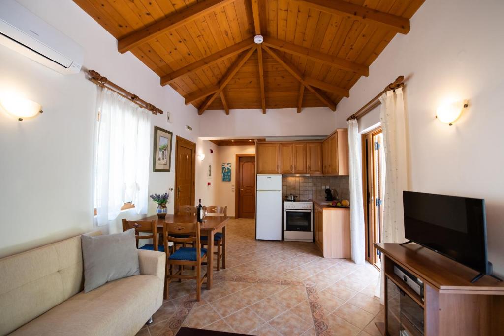 a living room with a couch and a table at Delphinus Villa Nefeli in Agios Nikitas