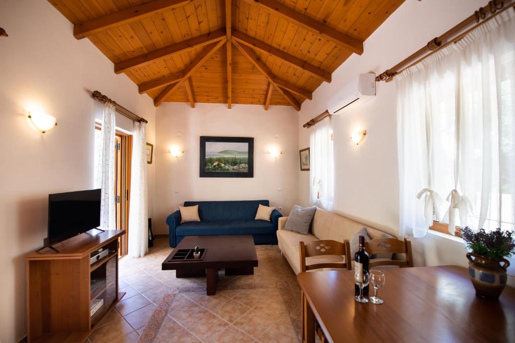 a living room with a couch and a table at Delphinus Villa Nefeli in Agios Nikitas