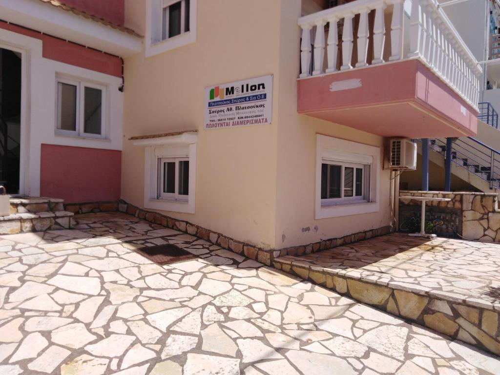 a house with a balcony and a stone floor at Marina in Kanali