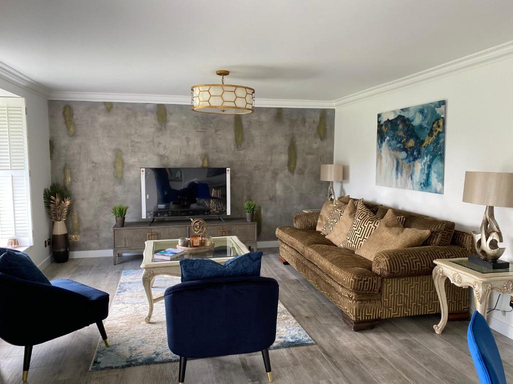 uma sala de estar com um sofá e uma mesa em Gleneagles Luxury Apartments em Auchterarder