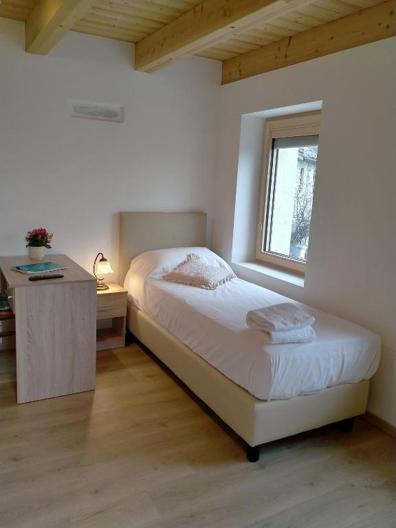 Postel nebo postele na pokoji v ubytování Antico Melo B&B