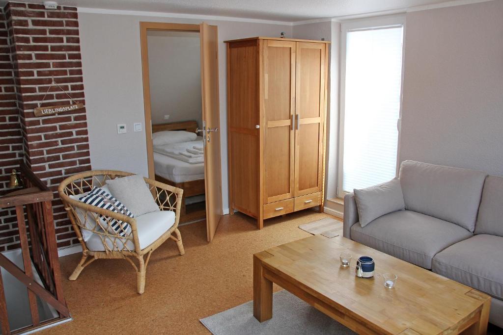 a living room with a couch and a table at Fischerhaus Lemkenhafen in Lemkenhafen auf Fehmarn