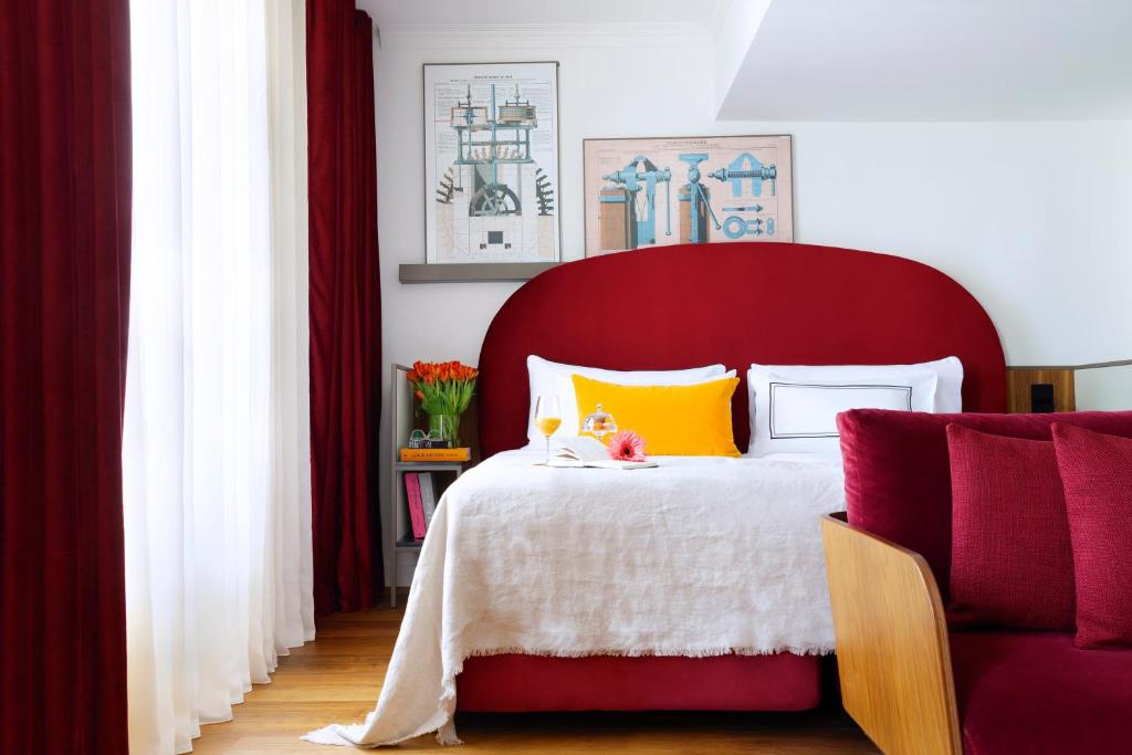 a red bed with a red headboard in a bedroom at Villa Marquis Member of Meliá Collection in Paris