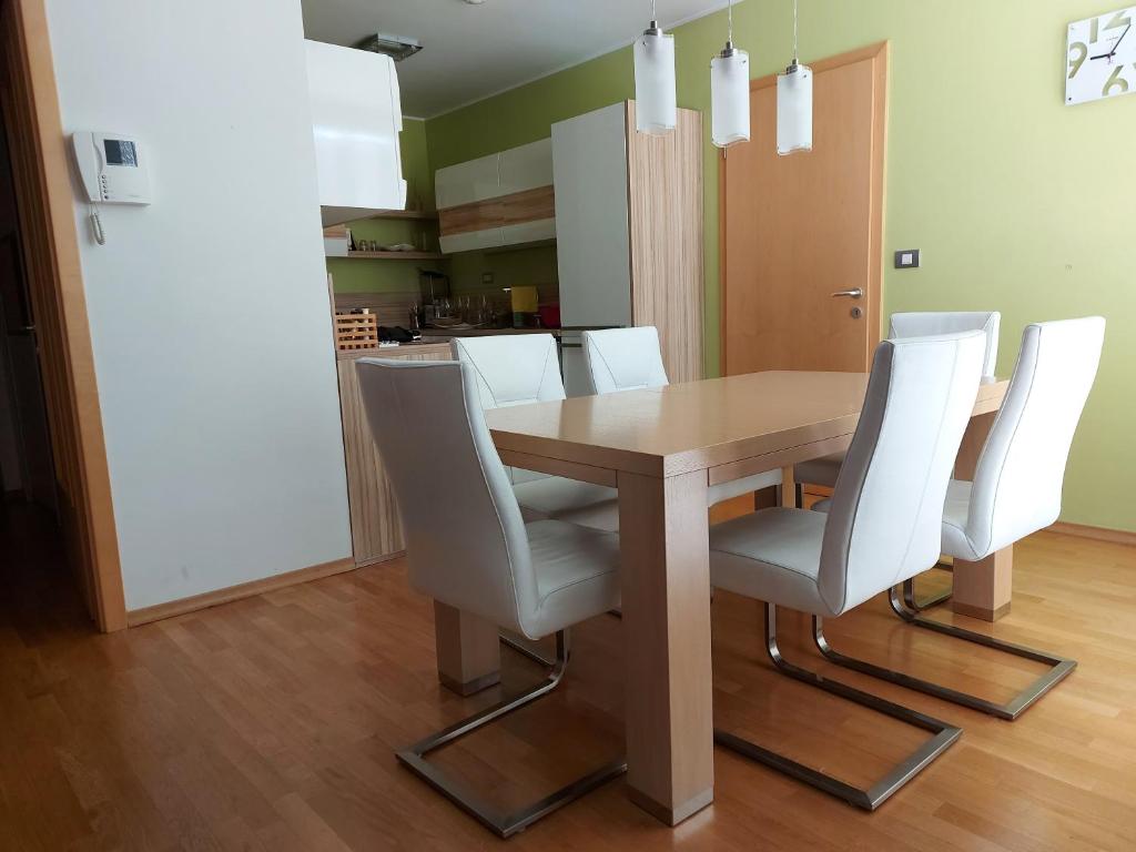 ein Esszimmer mit einem Tisch und weißen Stühlen in der Unterkunft Apartma Klara in Izola