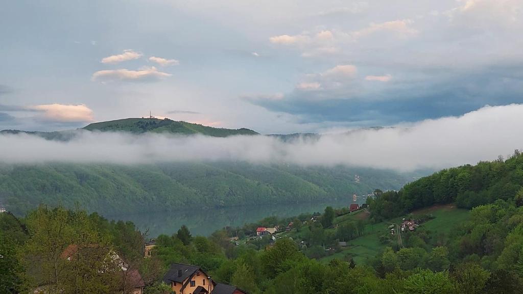 a view of a valley in the mountains with clouds at Mountain and Lake Views beautiful Miedzybrodzie in Międzybrodzie Bialskie