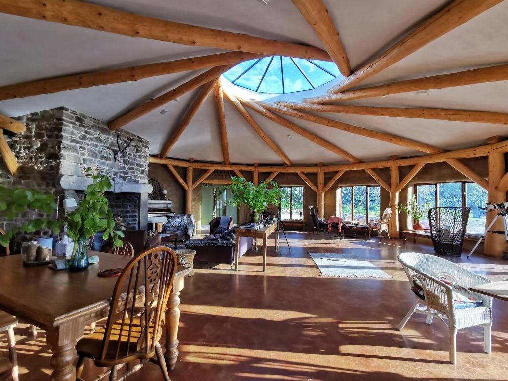 a living room with a large ceiling with wooden beams at Lough Mardal Lodge in Donegal