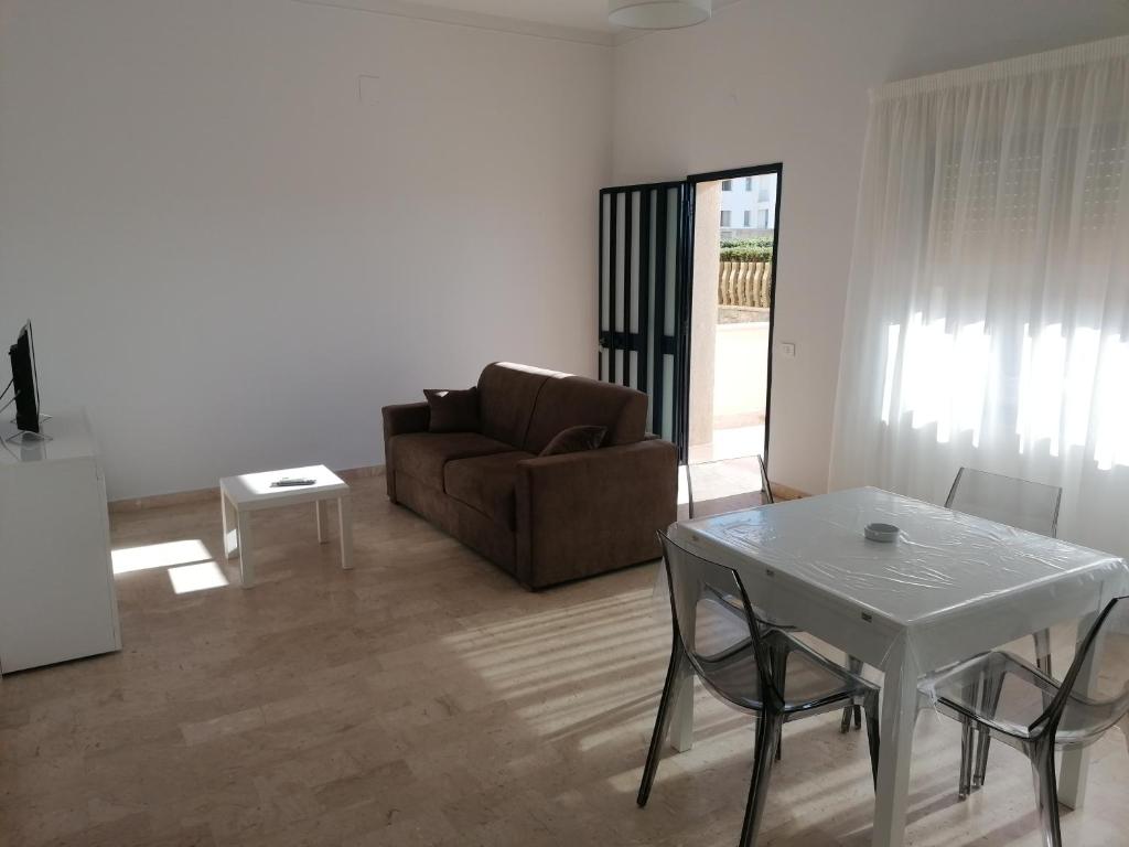 a living room with a white table and a couch at Zibibbo Beach Apartments - Trapani in Trapani