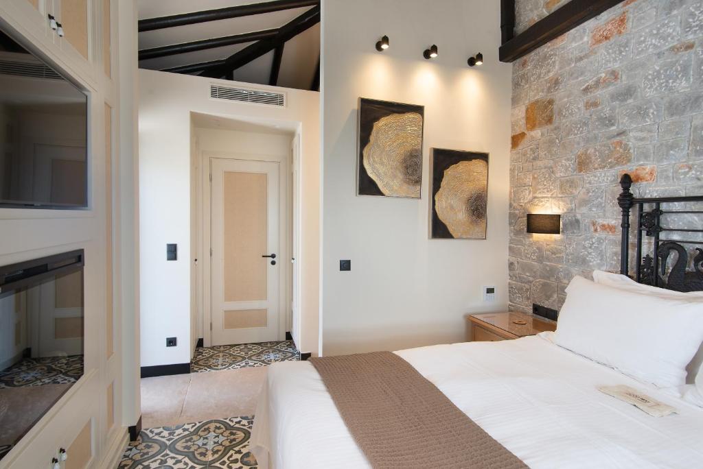 A bed or beds in a room at Polismata - Private Residences