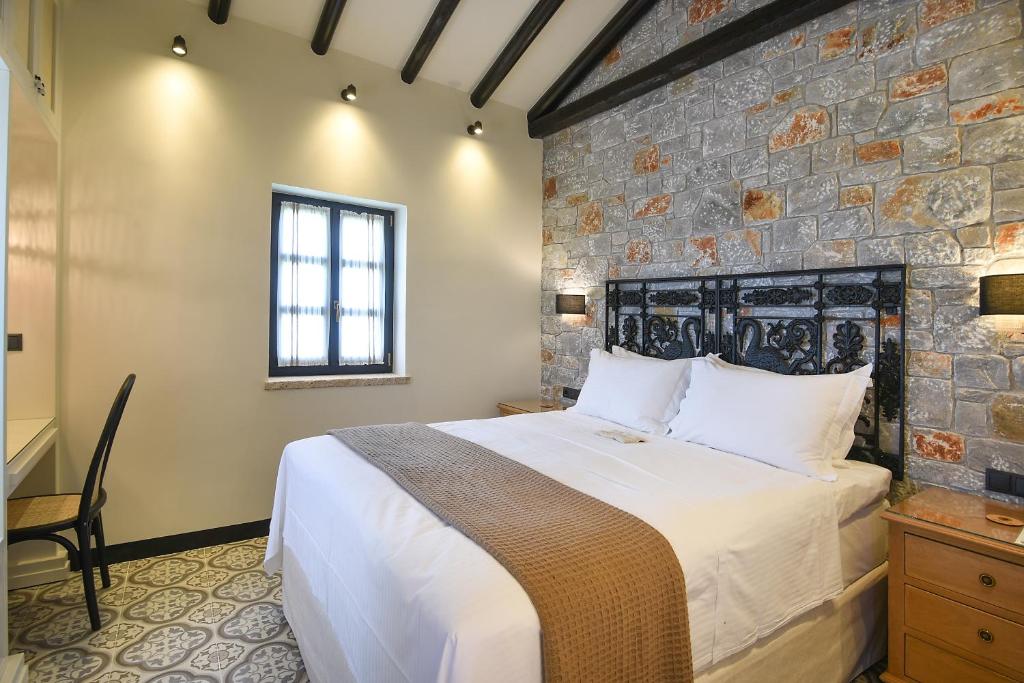 A bed or beds in a room at Polismata - Private Residences