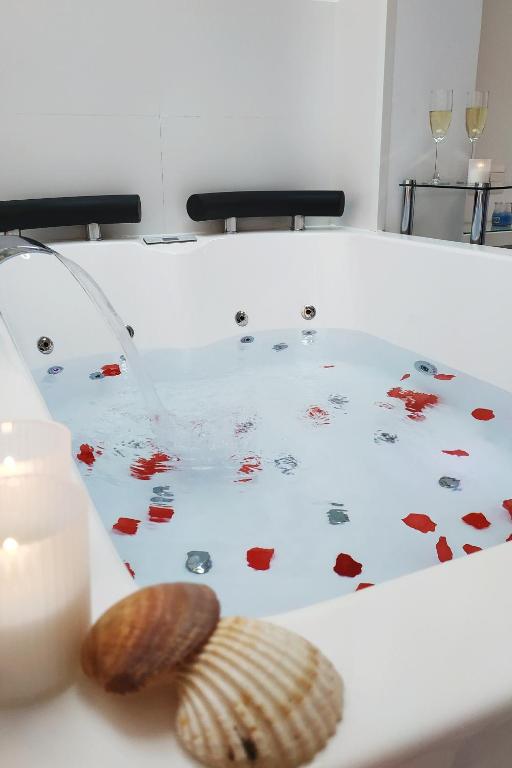Bañera de hidromasaje con pétalos de rosa y conchas