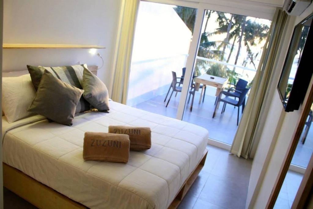 Postel nebo postele na pokoji v ubytování Zuzuni Boutique Hotel