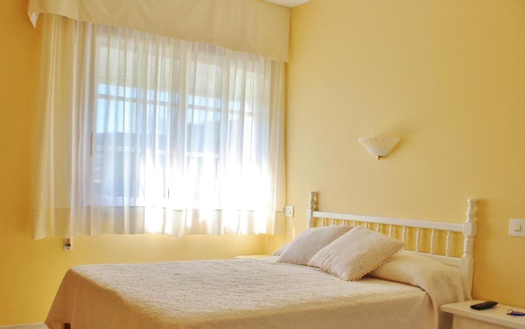 Posteľ alebo postele v izbe v ubytovaní Pensión Residencia Casa Teresa