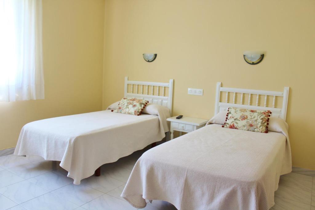 Posteľ alebo postele v izbe v ubytovaní Pensión Residencia Casa Teresa