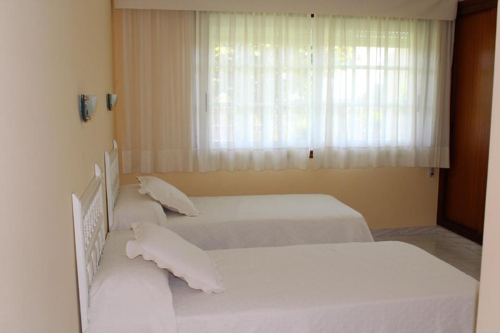 Posteľ alebo postele v izbe v ubytovaní Pensión Residencia Casa Teresa