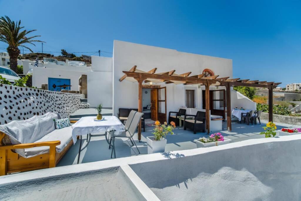 a villa with a pool and a table and chairs at MARIAS'VIEW HOUSE in Akrotiri