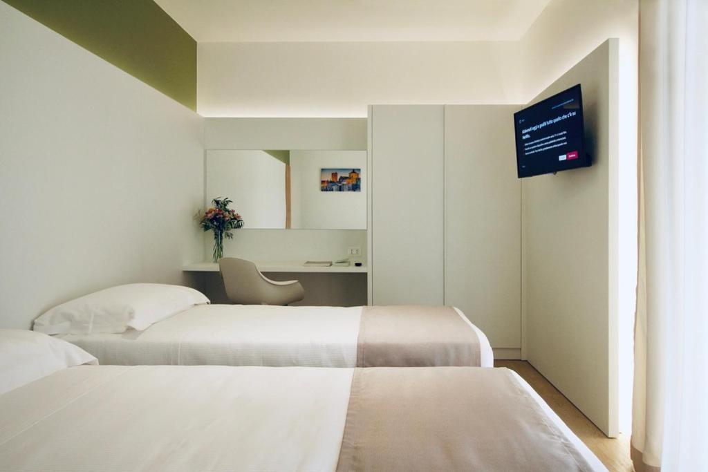 A bed or beds in a room at Hotel Olivò