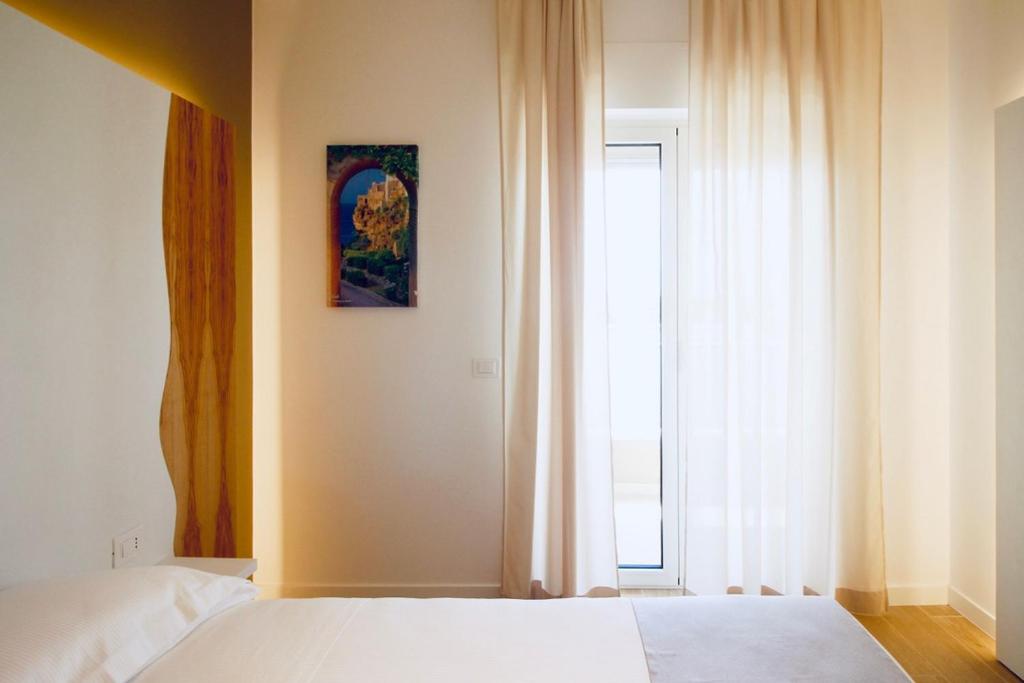 A bed or beds in a room at Hotel Olivò