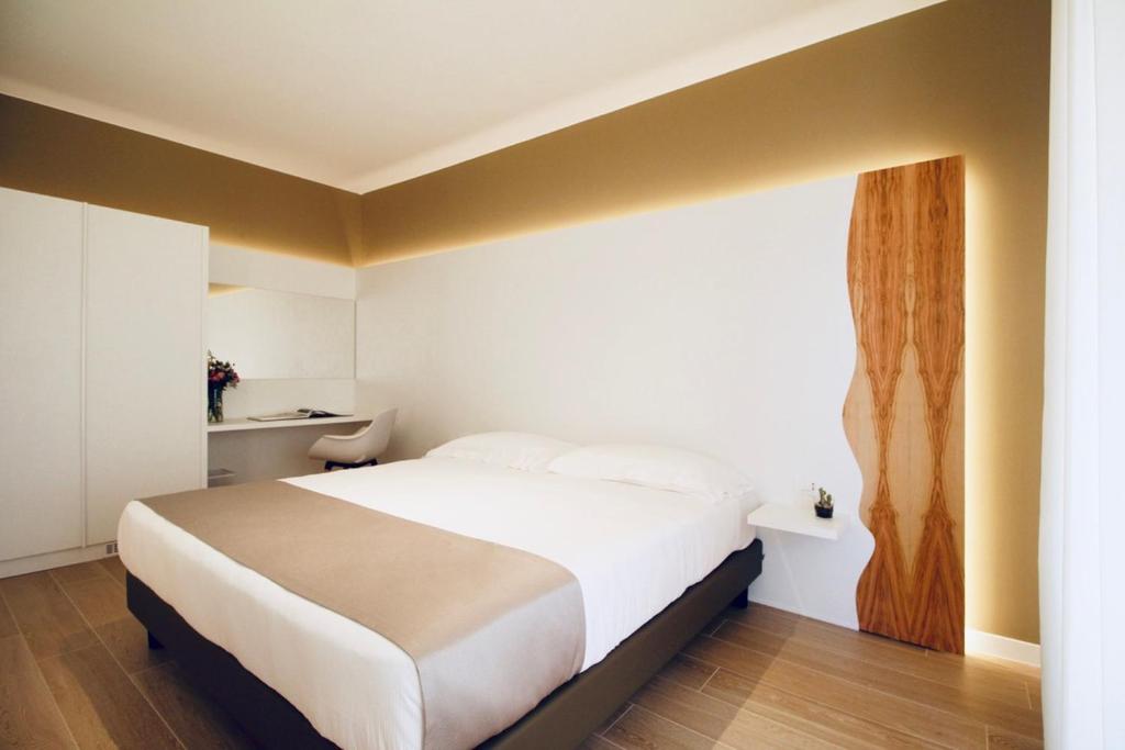 A bed or beds in a room at Hotel Olivò