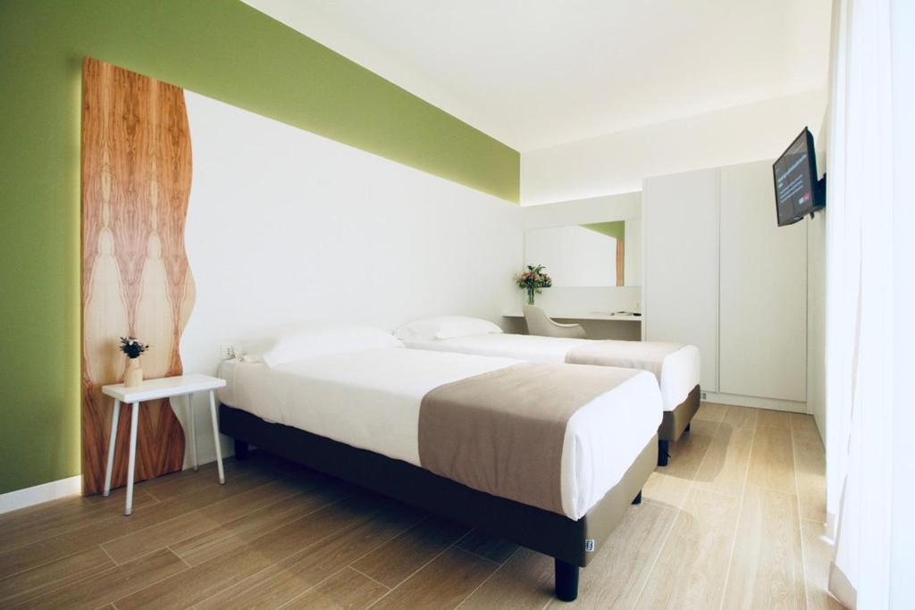 A bed or beds in a room at Hotel Olivò