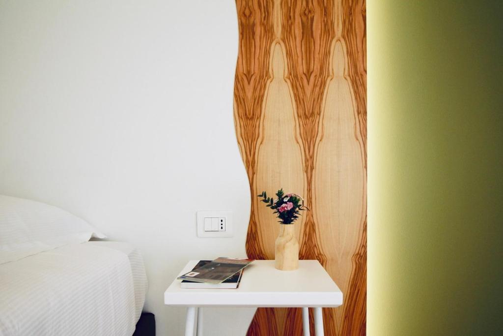 A bed or beds in a room at Hotel Olivò