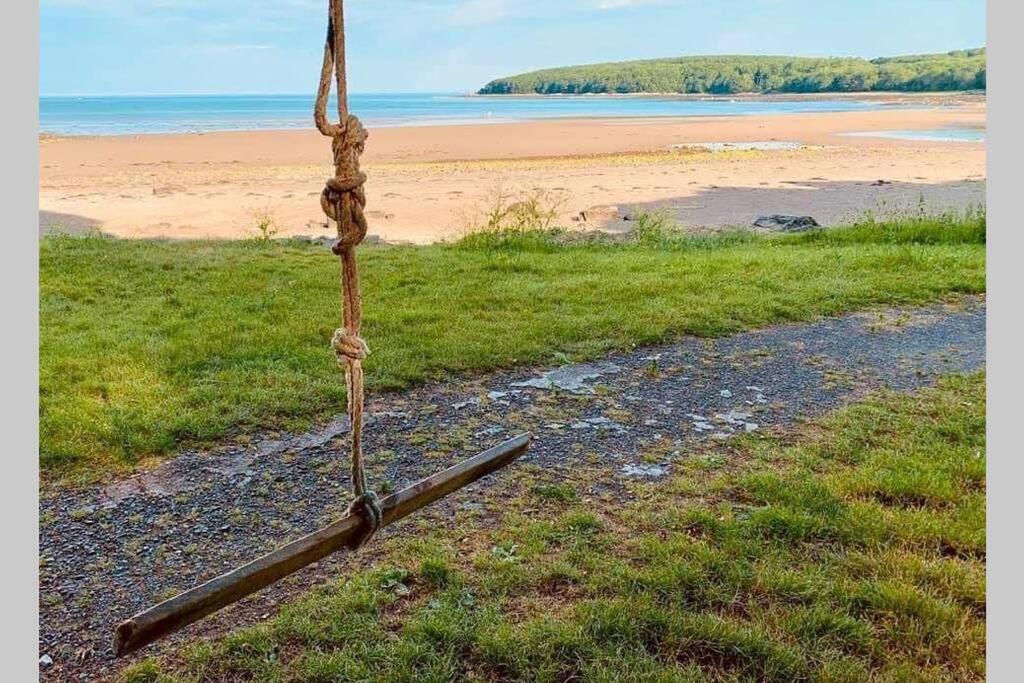 a wooden pole sitting on the side of a beach at Galloway Farmstay Broughton in Newton Stewart
