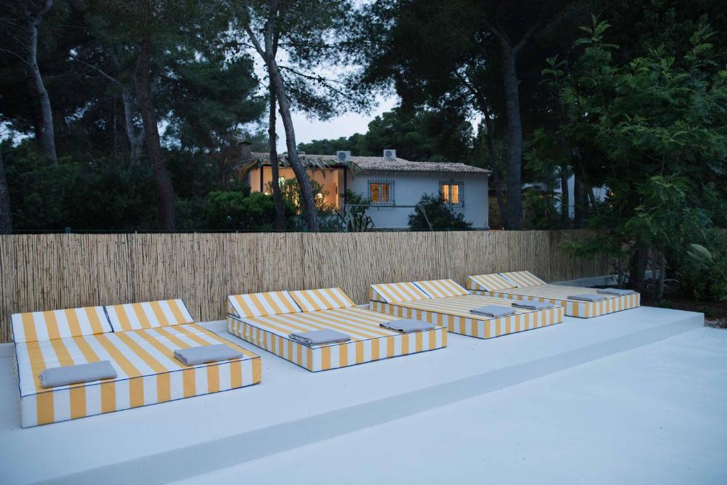 a row of chaise lounges in front of a fence at Quinta la Sal in Jávea