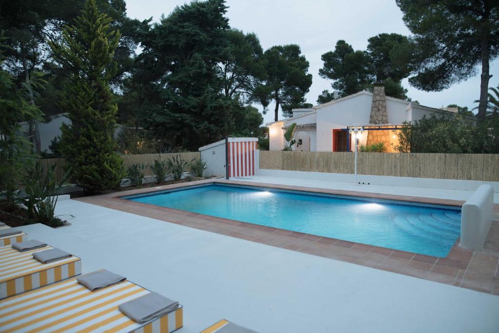 a swimming pool in the backyard of a house at Quinta la Sal in Jávea