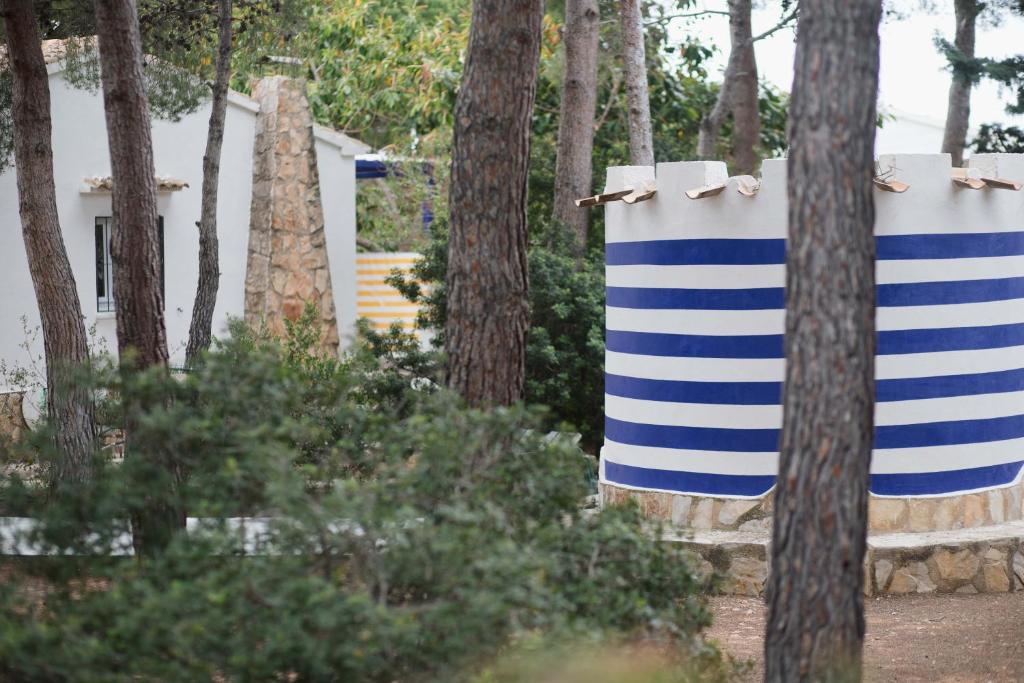 two blue and white striped towels hanging from trees at Quinta la Sal in Jávea