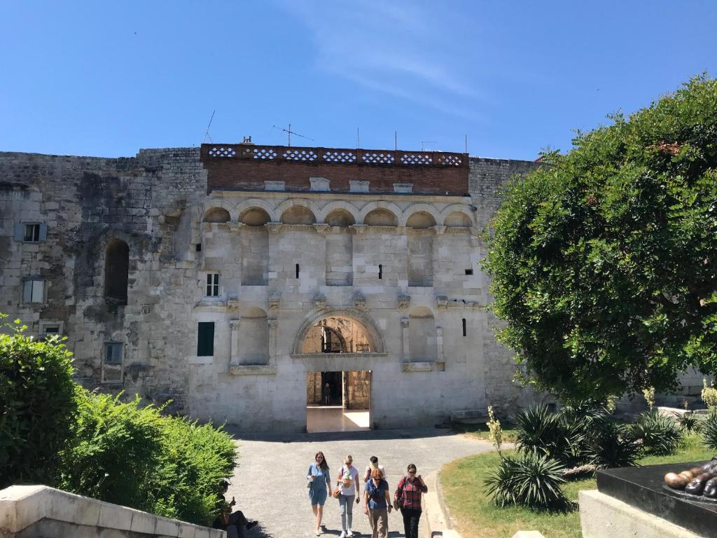 a group of people standing in front of a castle at Central Park Residence in Split