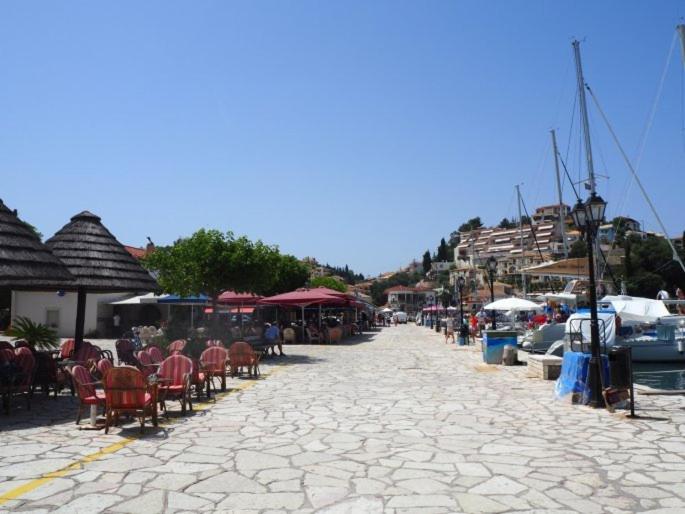 a cobblestone street with tables and chairs and boats at Sivotahomes-blu in Syvota