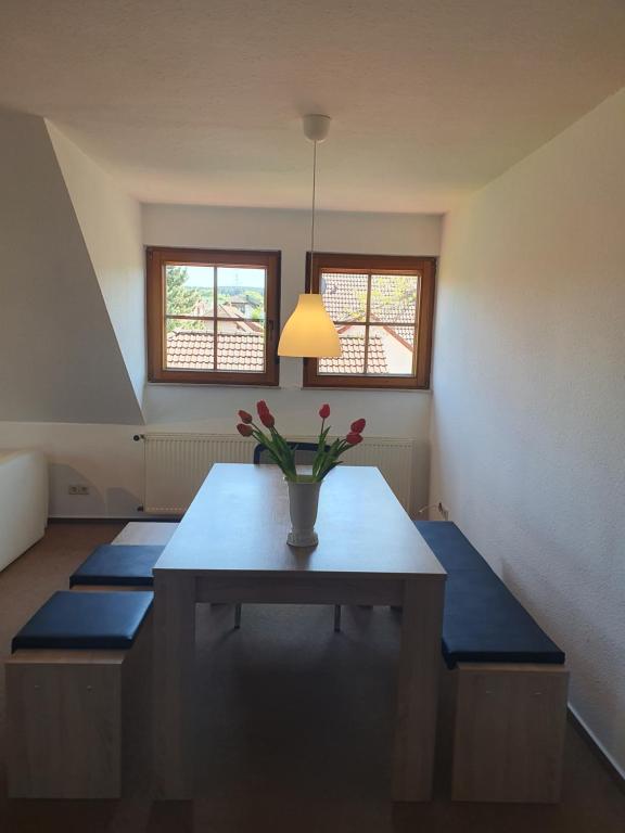 a dining room with a table with flowers on it at Ferienwohnung im Schwarzwaldhaus in Behla