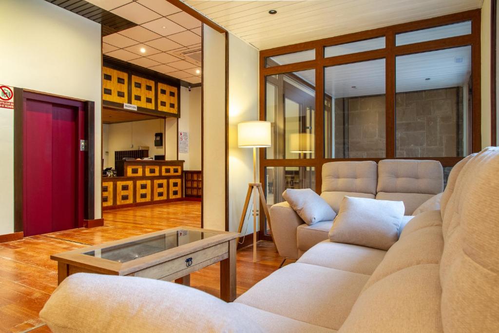 a living room with couches and a coffee table at Hotel Boltaña Ordesa in Boltaña