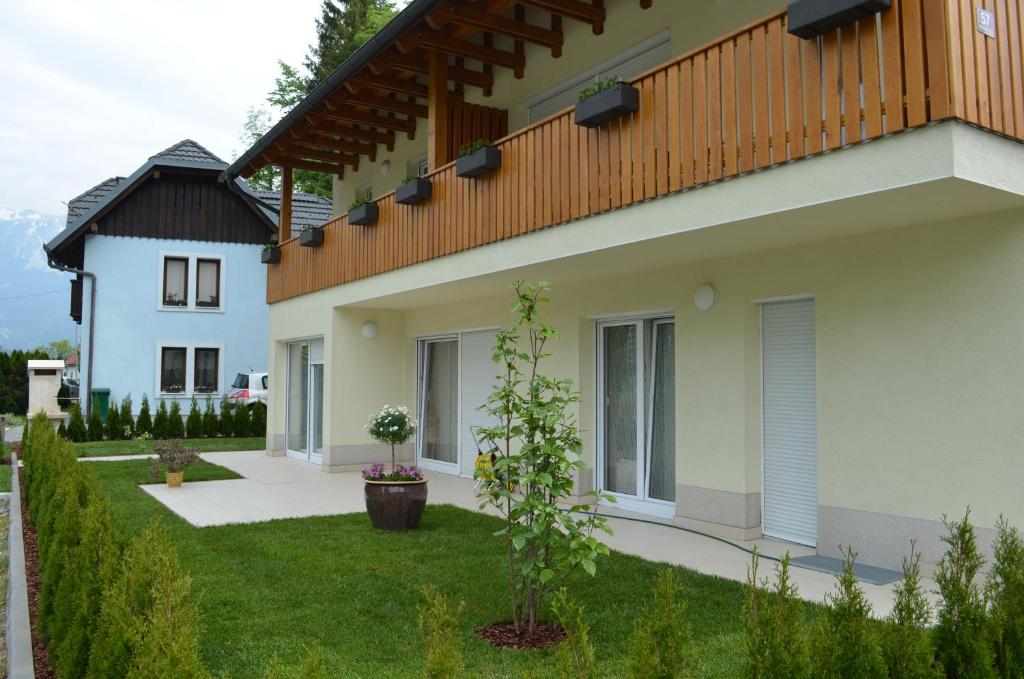 a house with a balcony on the side of it at Apartments Sofija in Bled