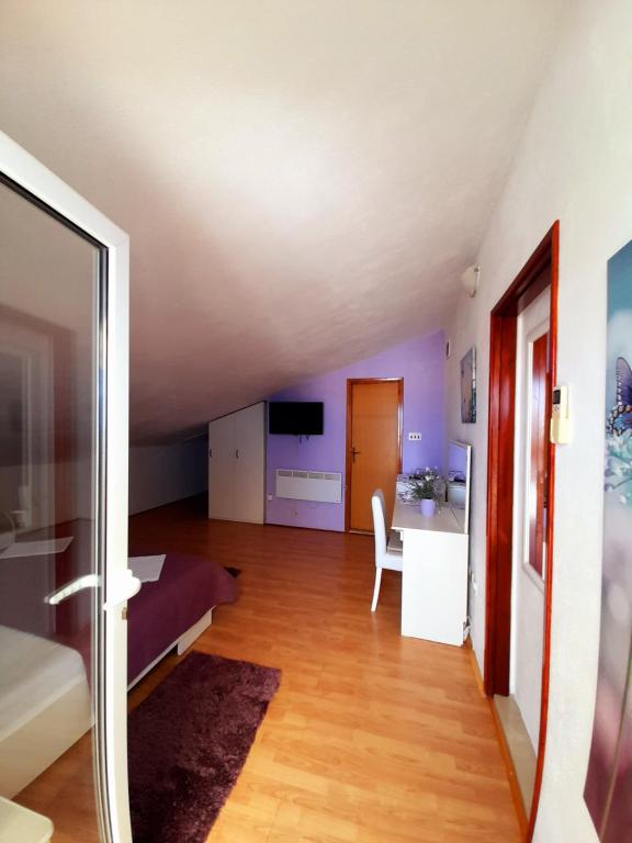 a living room with a bed and a desk at Apartments and Rooms Jasna in Hvar