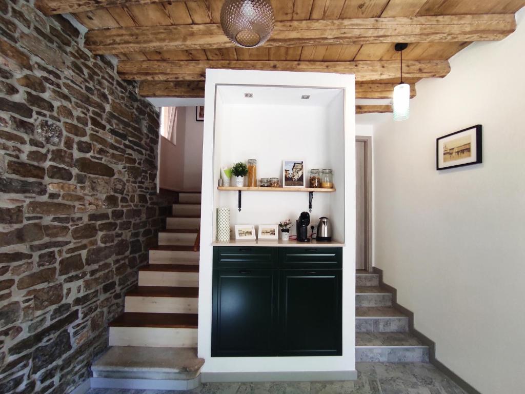 a hallway with a green cabinet and a brick wall at Lighthouse.Izola in Izola