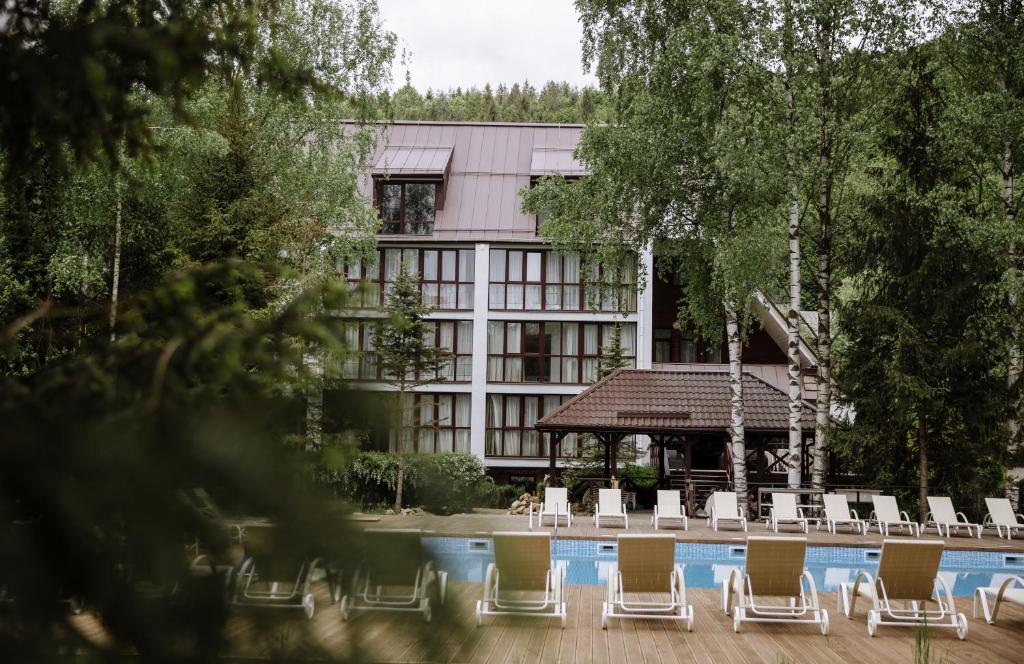 a group of chairs sitting in front of a building at Yaremche Club Hotel in Yaremche
