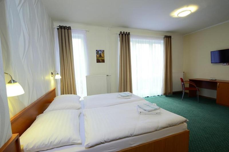 Postel nebo postele na pokoji v ubytování Wellness Penzion Kotár