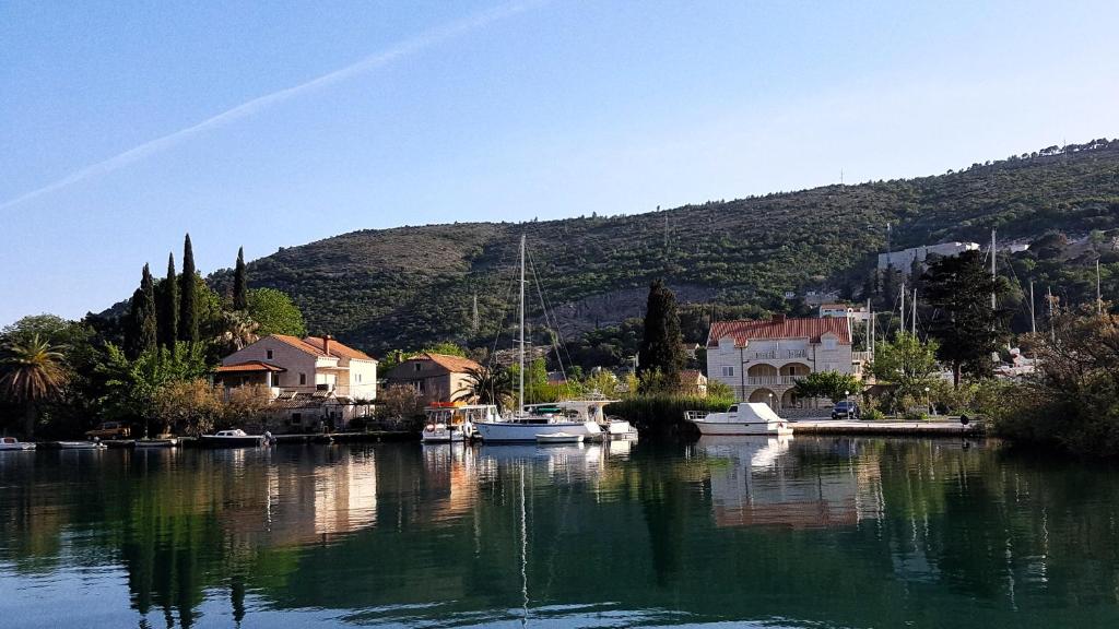 a group of boats docked in a body of water at Apartments Lorena in Mokošica