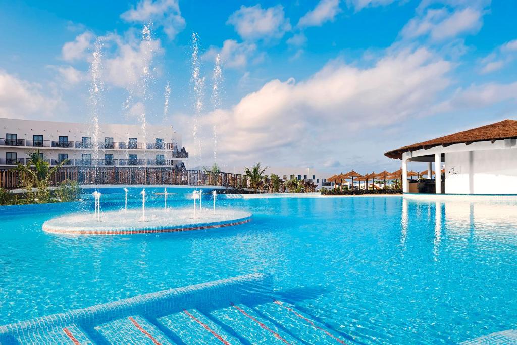 a large swimming pool with a fountain in the middle at Melia Dunas Beach Resort & Spa - All Inclusive in Santa Maria