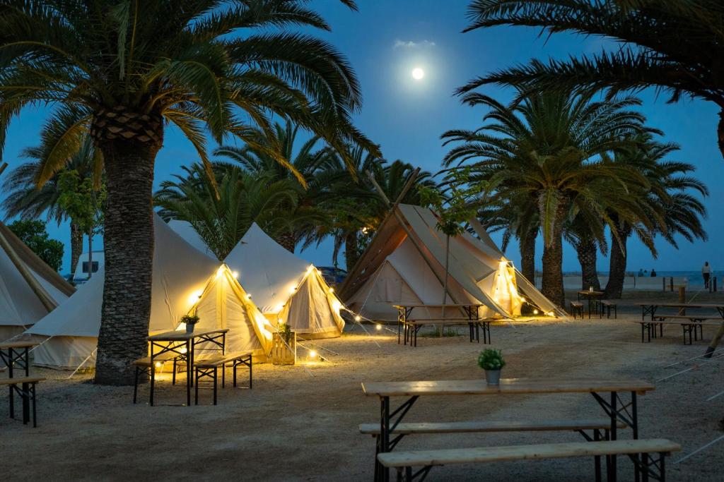 a group of tents on the beach at night at Kampaoh Costa Dorada in Creixell