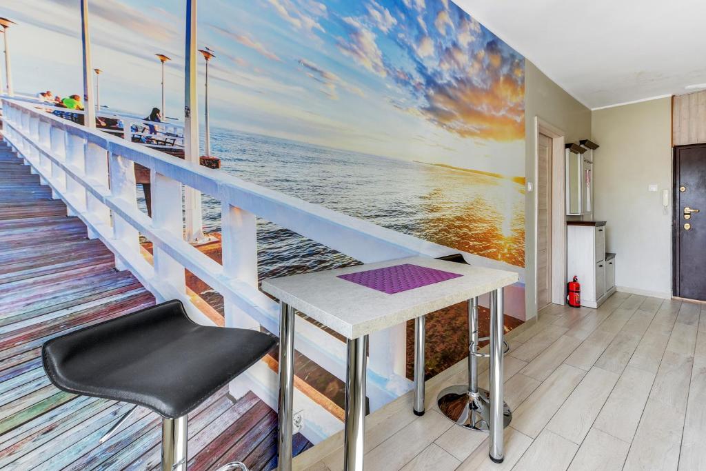 a room with a table and a view of the ocean at Sopot Baltic Sands Apartment by Grand Apartments in Sopot