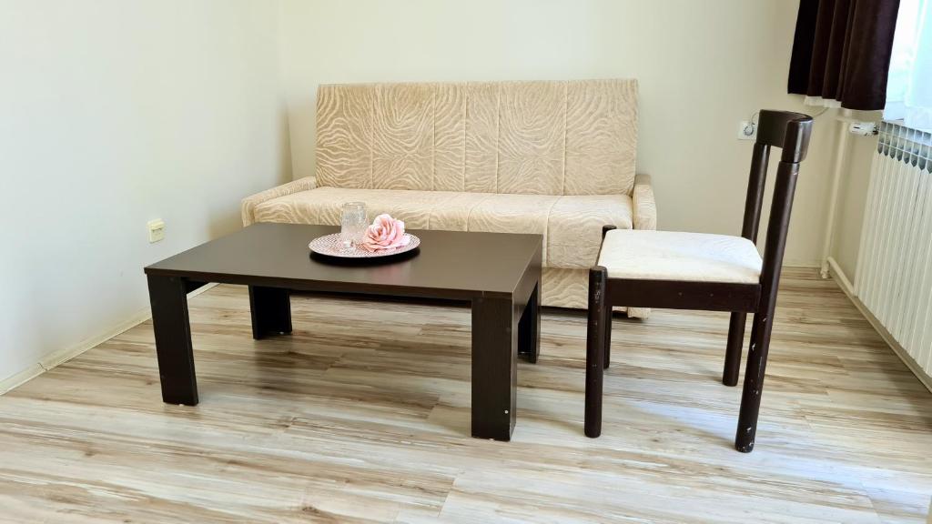 a living room with a table and a chair at Hotel Royal Drina in Mali Zvornik